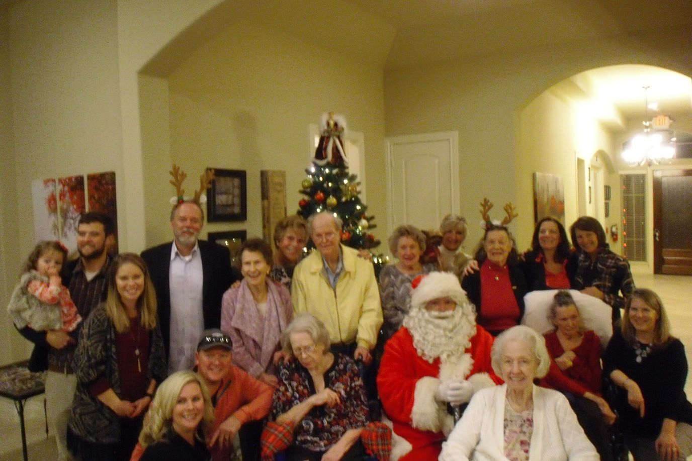 Residents and staff celebrating with Santa during a holiday event