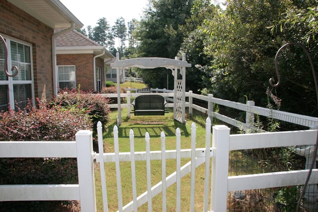 Tranquil garden swing in a fenced area