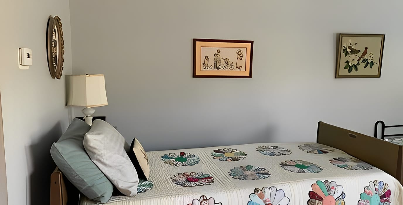 A cozy bedroom with a decorated bed and wall art.