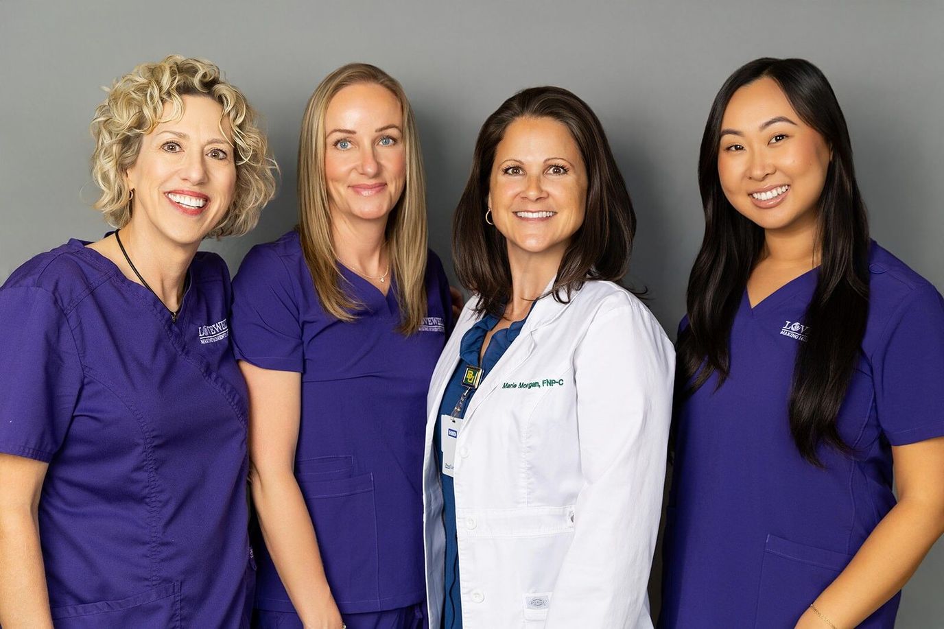 Staff members posing together in professional attire