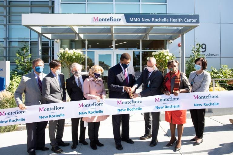 Ribbon-cutting ceremony at the health center entrance.