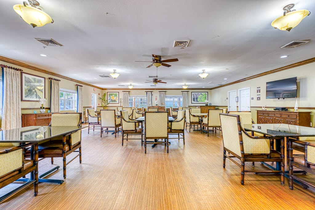 Spacious common area with tables and chairs in Cottages at Belleair.