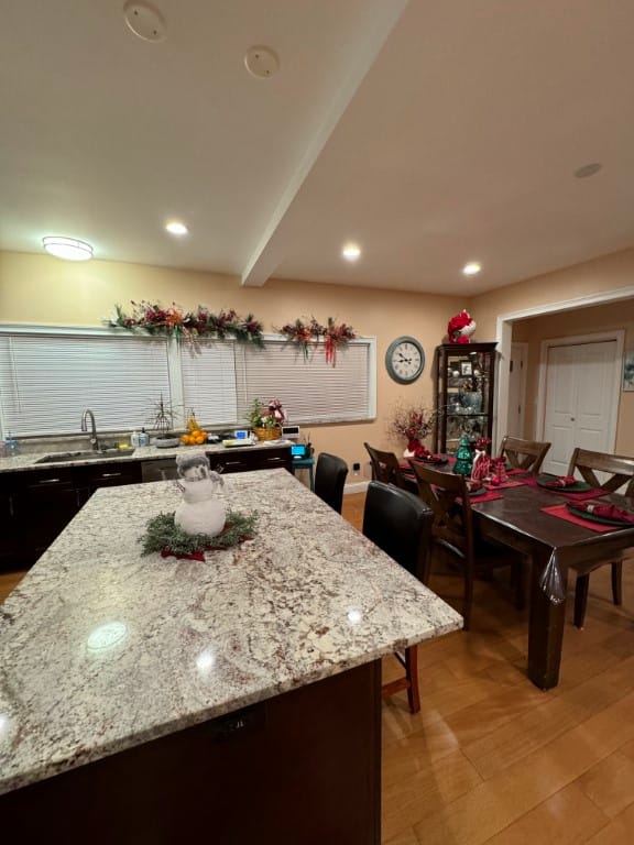A beautifully decorated kitchen with a granite island and dining area.
