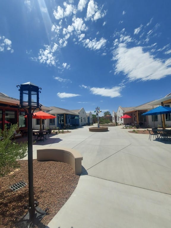 Open courtyard with colorful umbrellas and a fountain