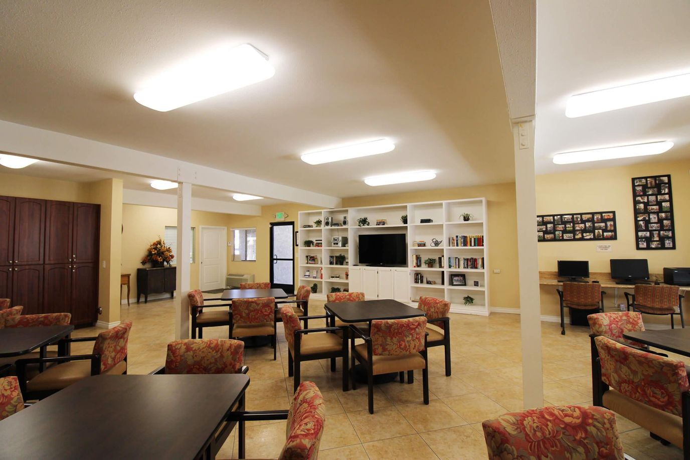 Light-filled community room with seating and shelves