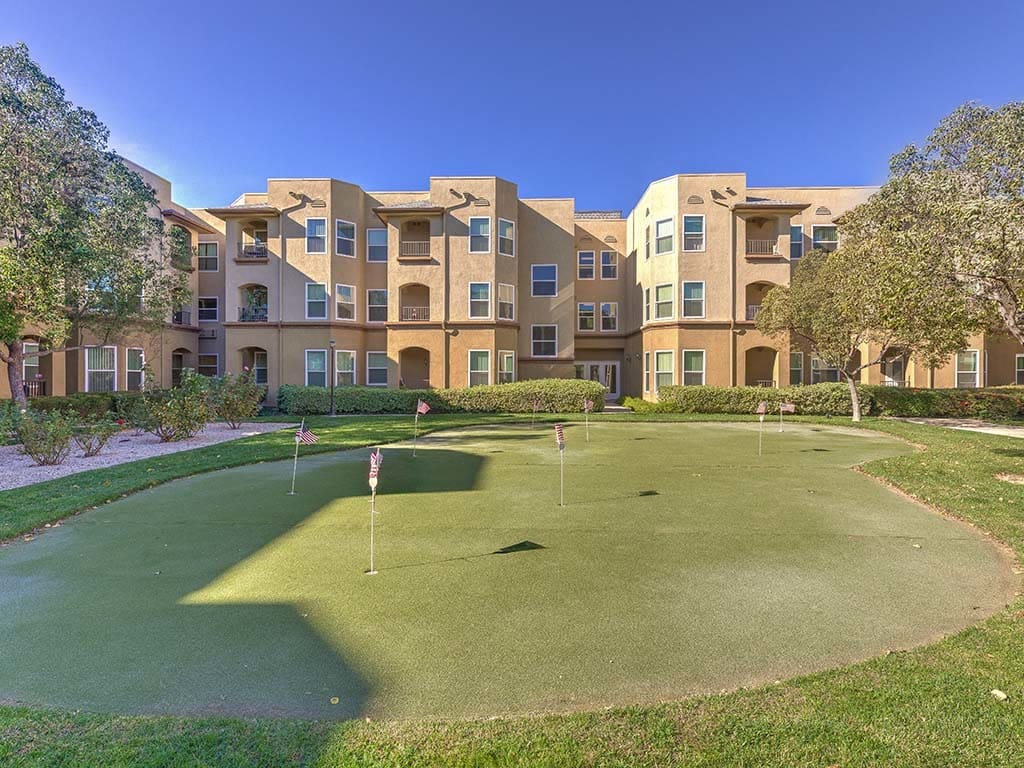 Putting green with flags in front of the building