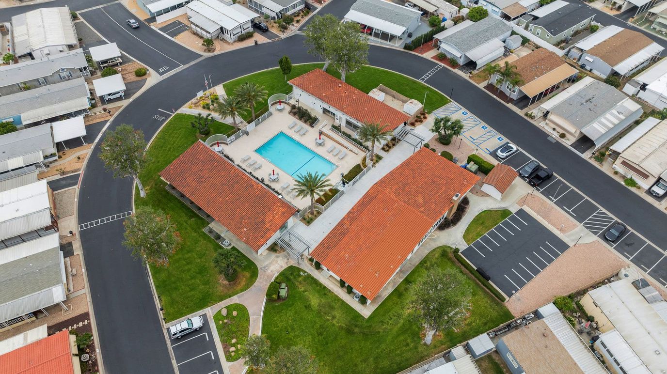 Aerial view of a senior living facility with a pool and outdoor space