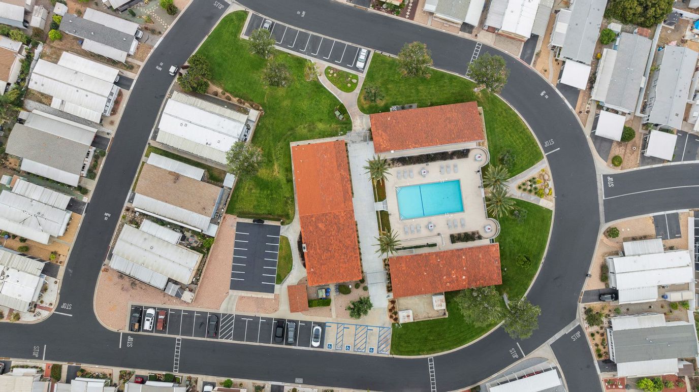 Aerial view of a senior living facility with pool and outdoor space