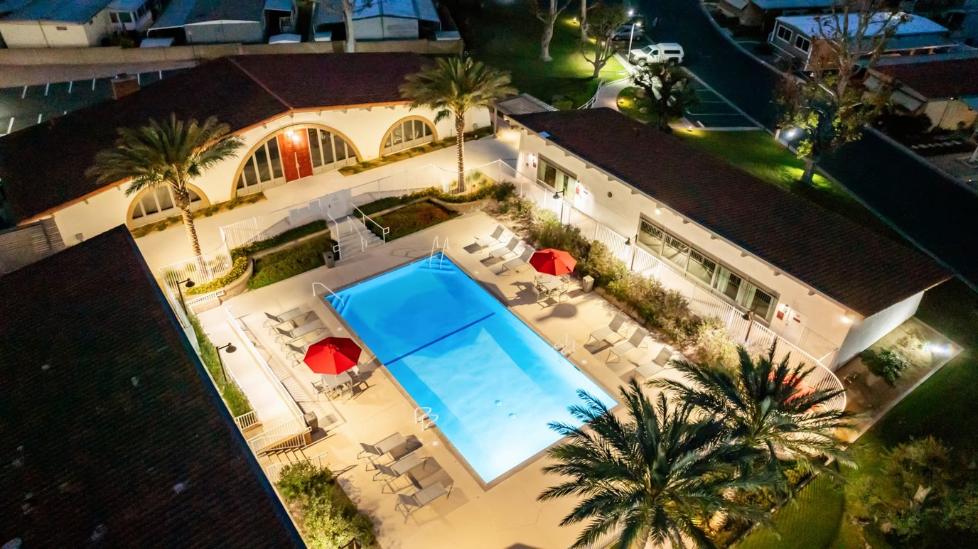 Aerial view of the pool area with lounge chairs and umbrellas