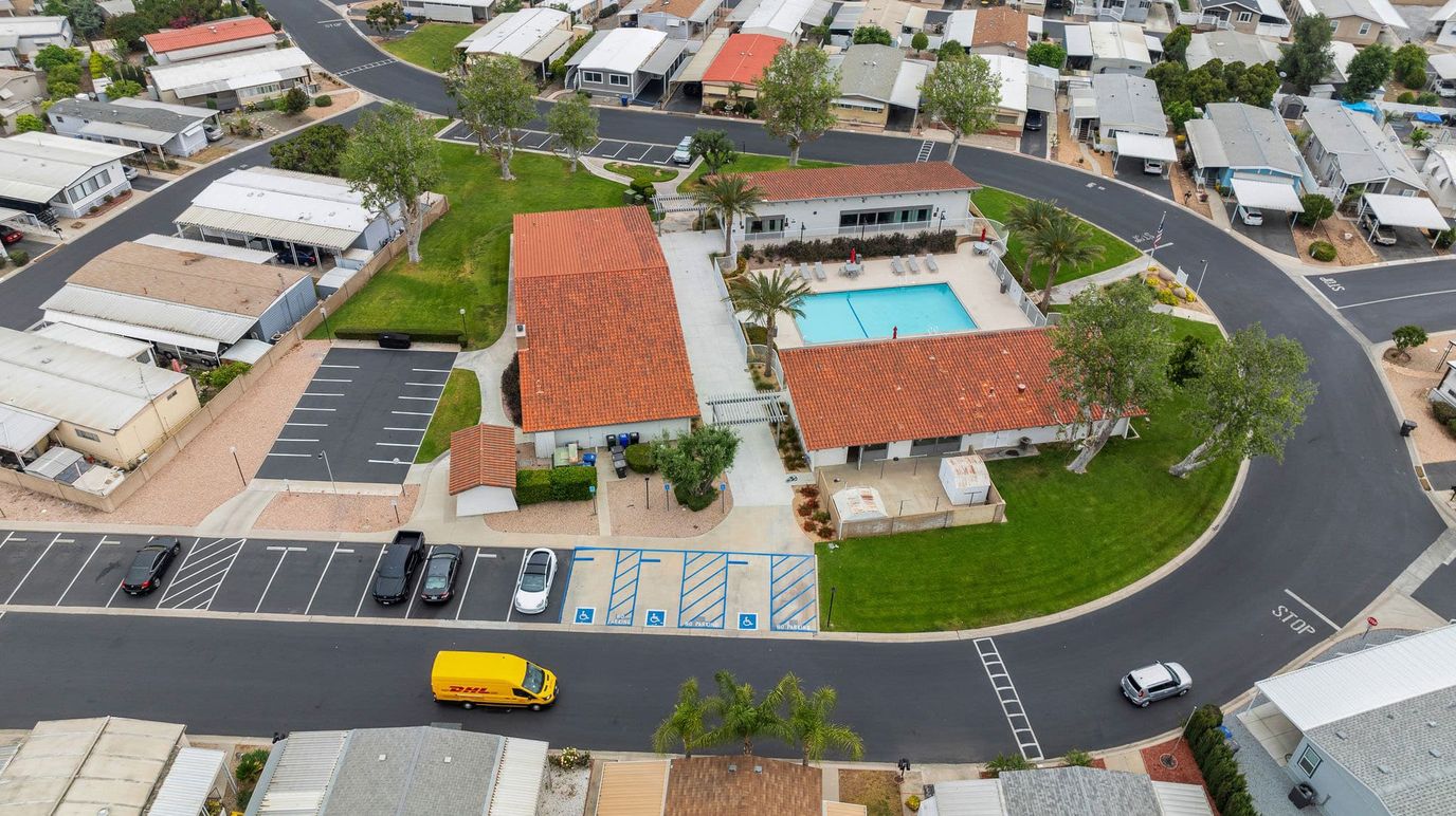 Aerial view of a senior living facility with pool and gardens