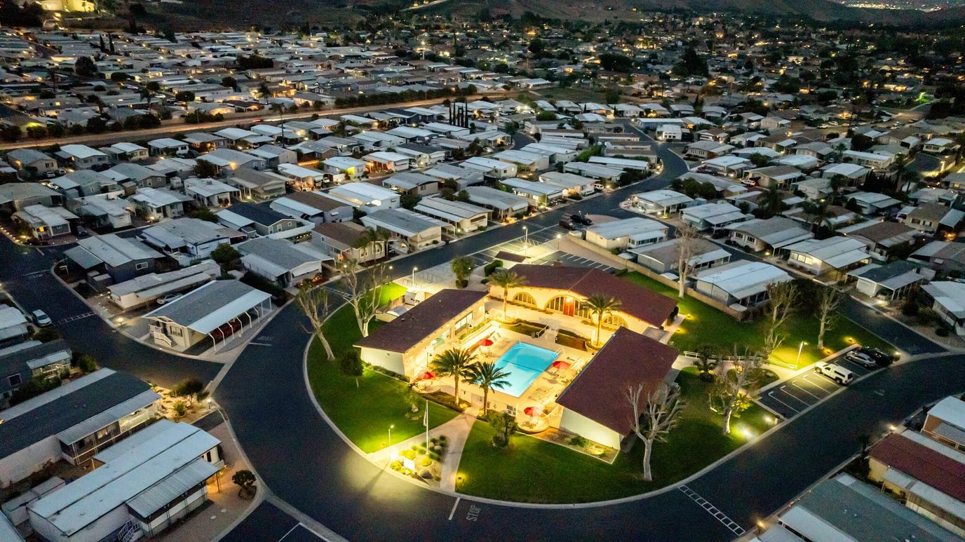 Aerial view of the facility with pool and surrounding homes