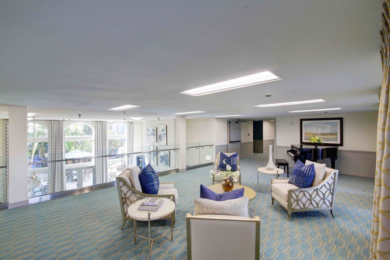 Bright common area with comfortable seating and piano