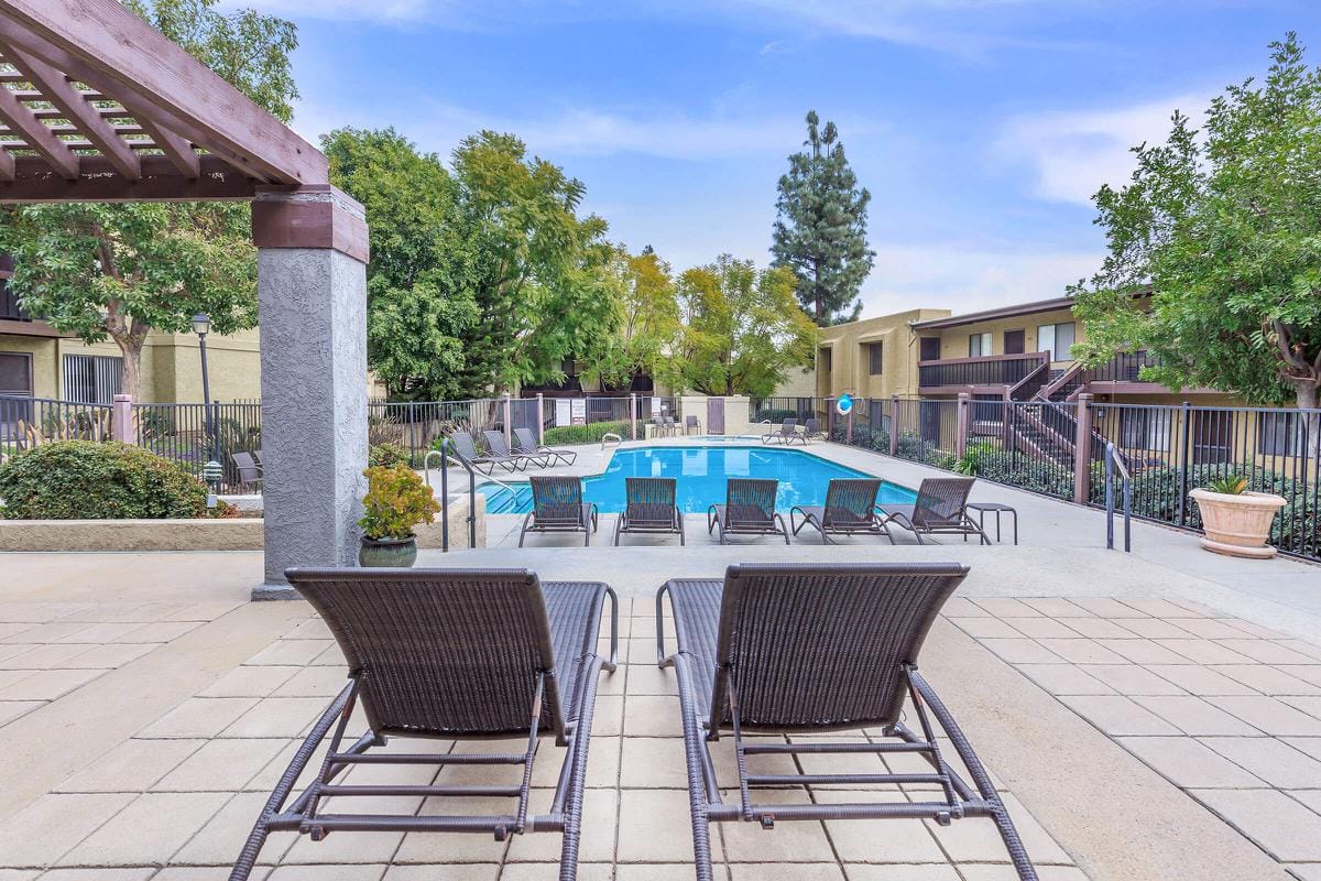View of the pool area with lounge chairs at Heritage Park Alta Loma