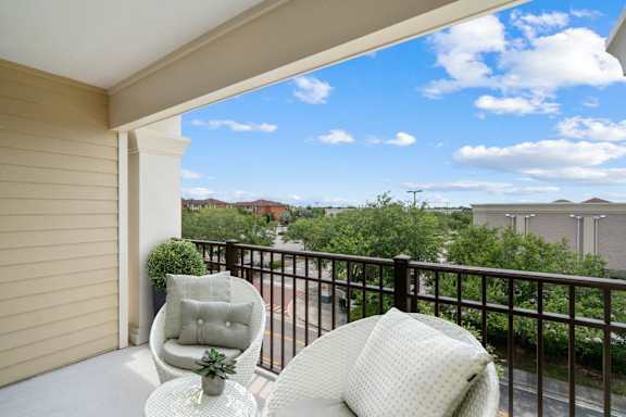 Balcony view with seating and greenery