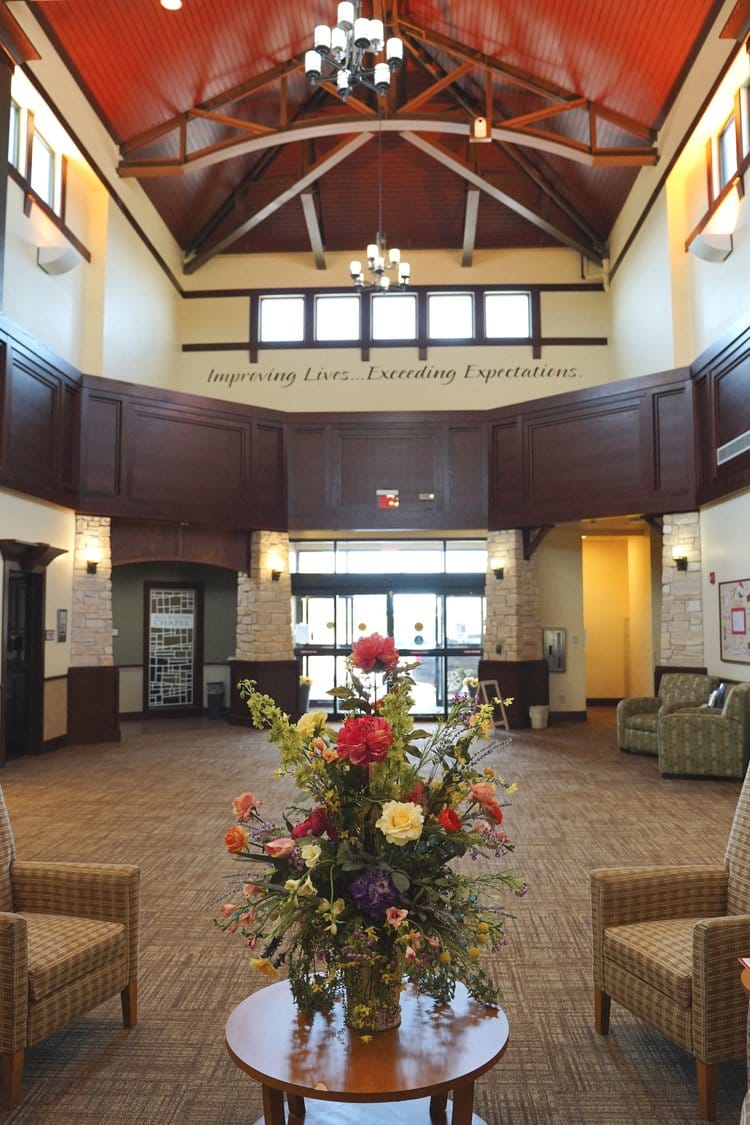 Welcoming lobby area with floral arrangement and seating
