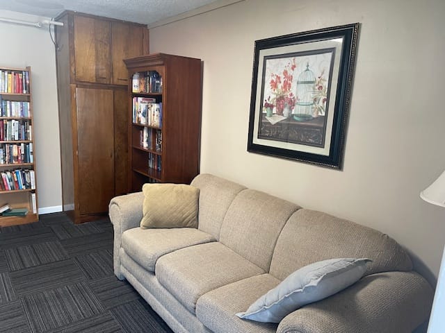 Comfortable beige couch with decorative pillows in a living room setting
