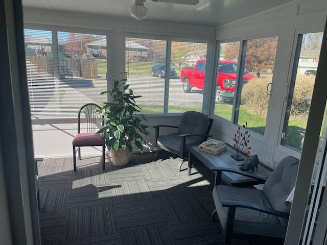 Bright sunroom with seating and plants