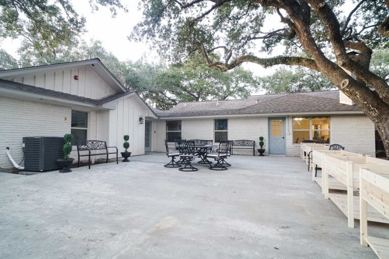 Patio area with seating at Village Forest Care Cottage