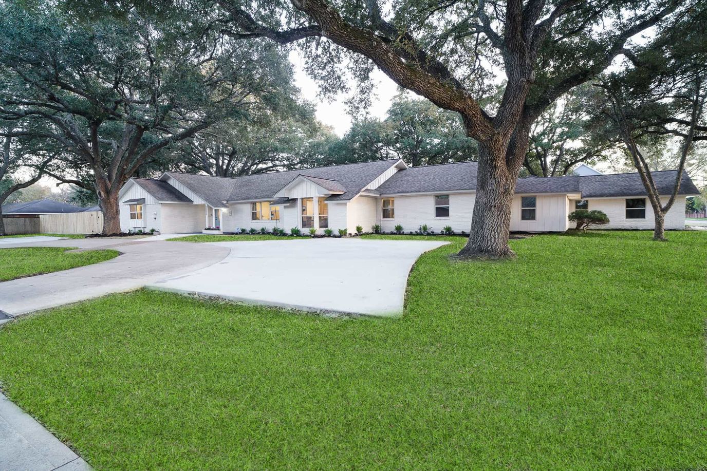 Front view of Village Forest Care Cottage with green lawn and trees