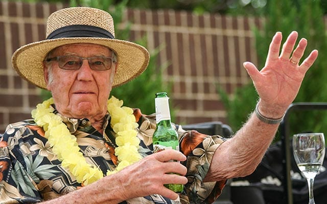 Senior resident enjoying a drink at an outdoor event
