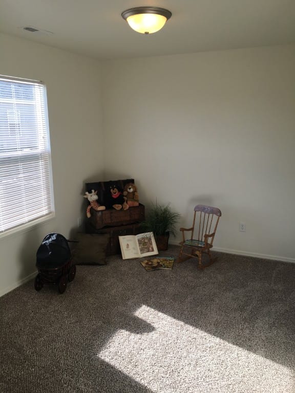 Bright, cozy room with a rocking chair, toys, and books