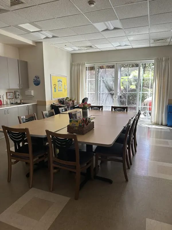 Bright and spacious common area with large table and chairs