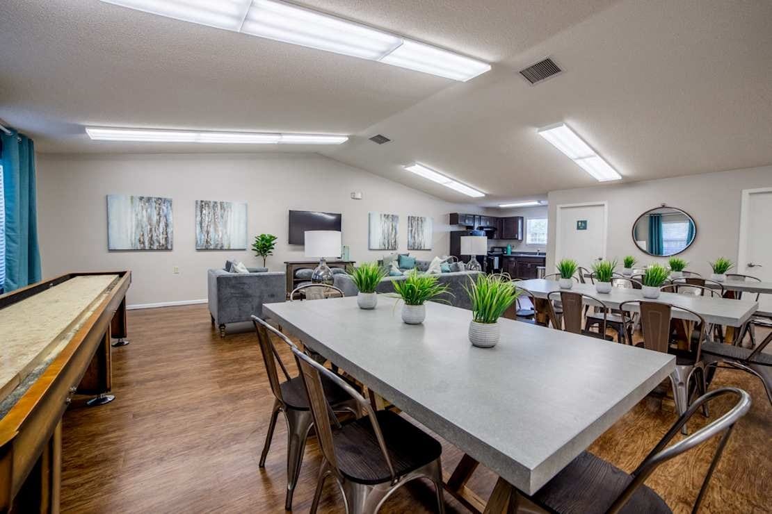 Bright common area with dining tables and seating