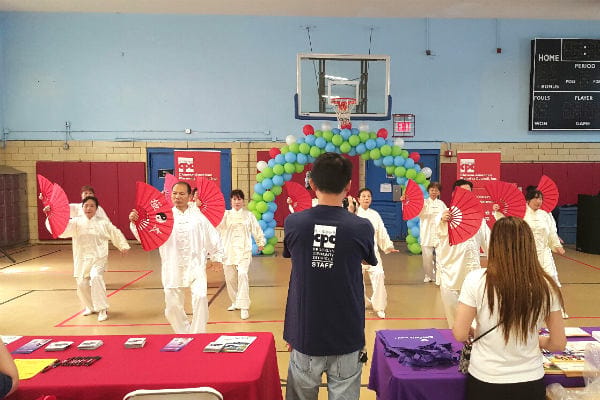 Residents performing in a group activity with fans.