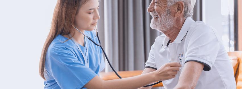 Healthcare professional checking a senior man's vitals.