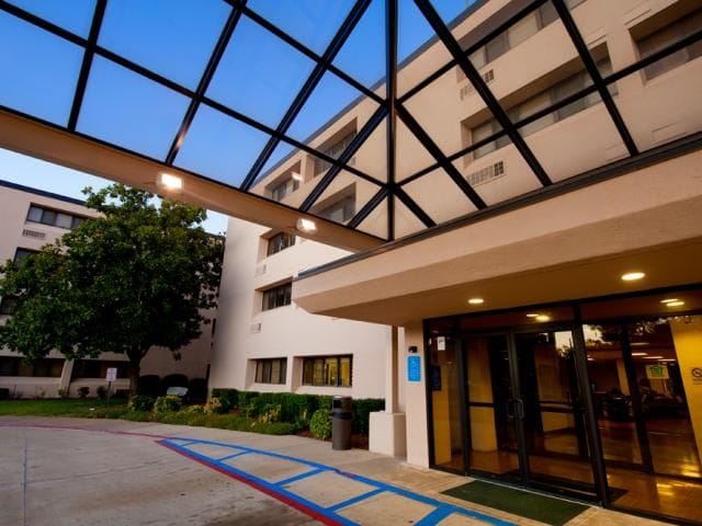 Entrance of Cedar Hills Senior Apartments with glass canopy