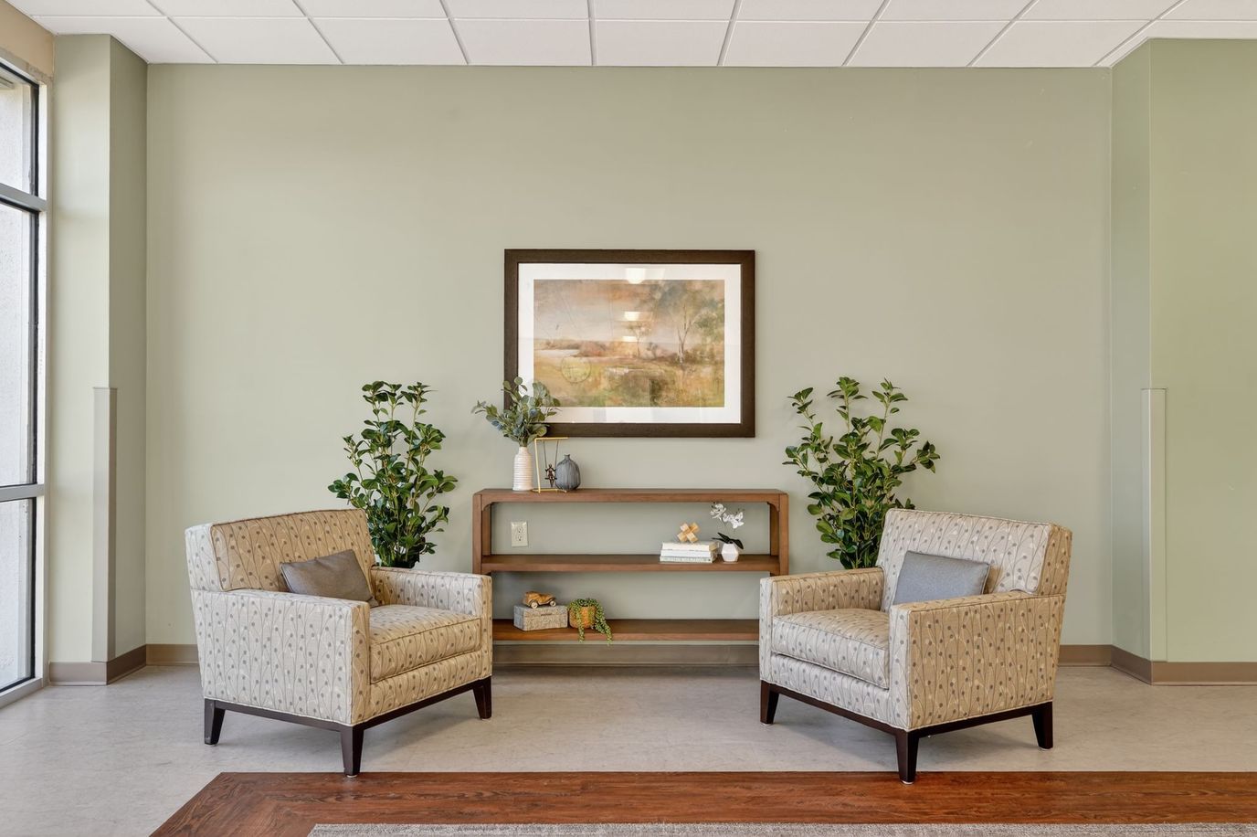 Chairs in a well-lit common area with artwork