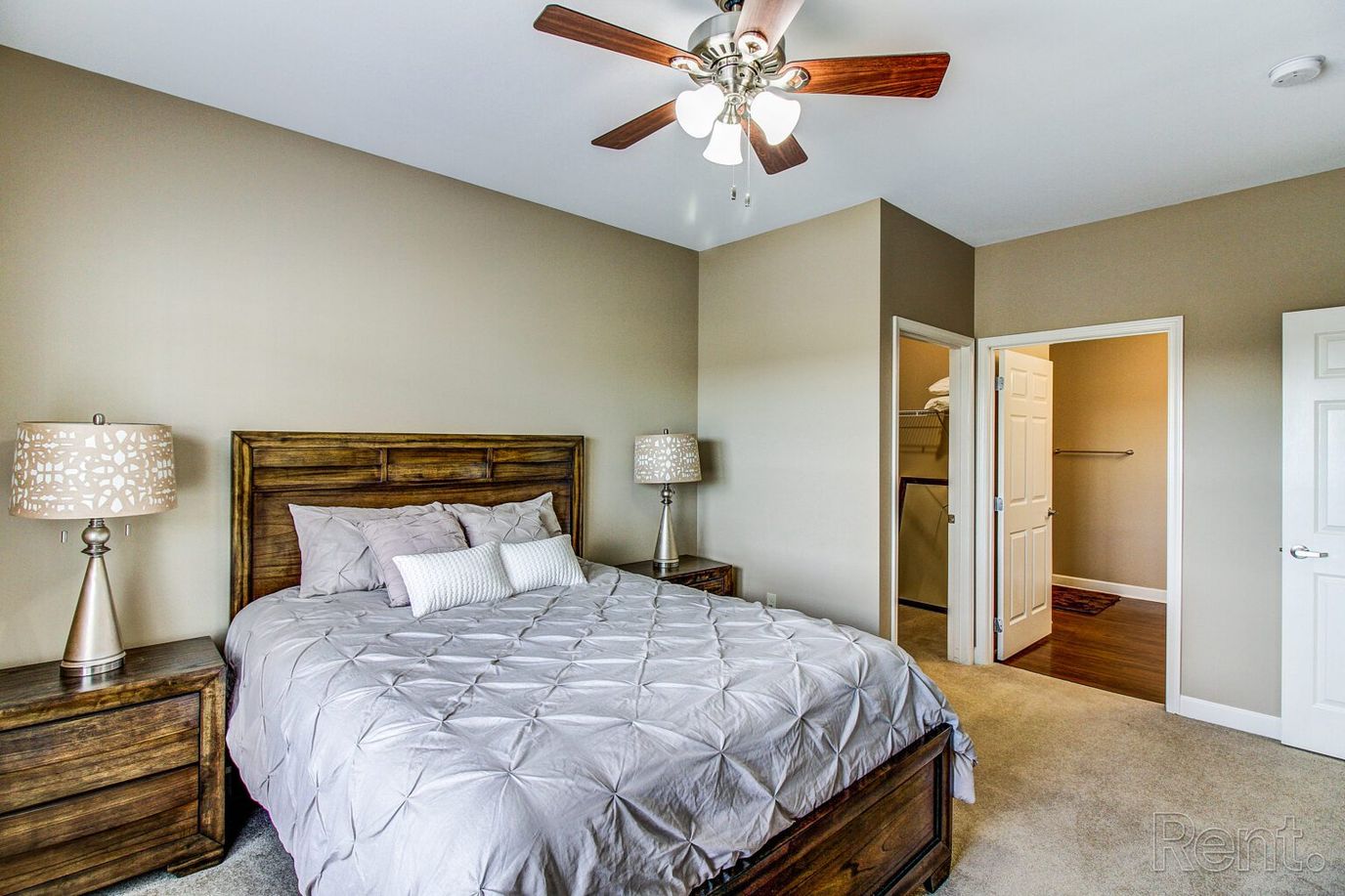 Bright interior of a resident room with a bed and lamps