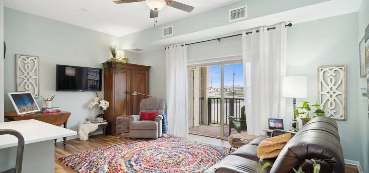 Modern living room with a television and balcony access