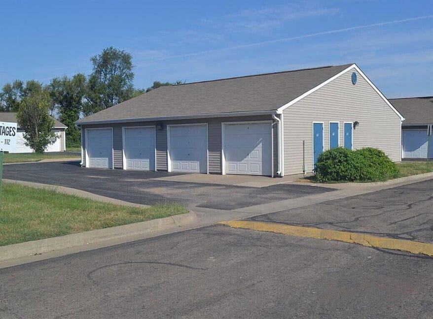 Garage building with multiple doors at Cottages of Topeka