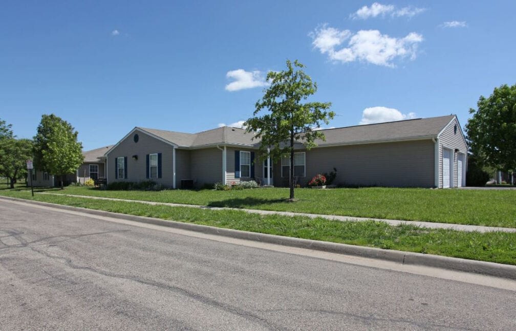 Exterior of Cottages of Topeka Senior Apartments on a sunny day
