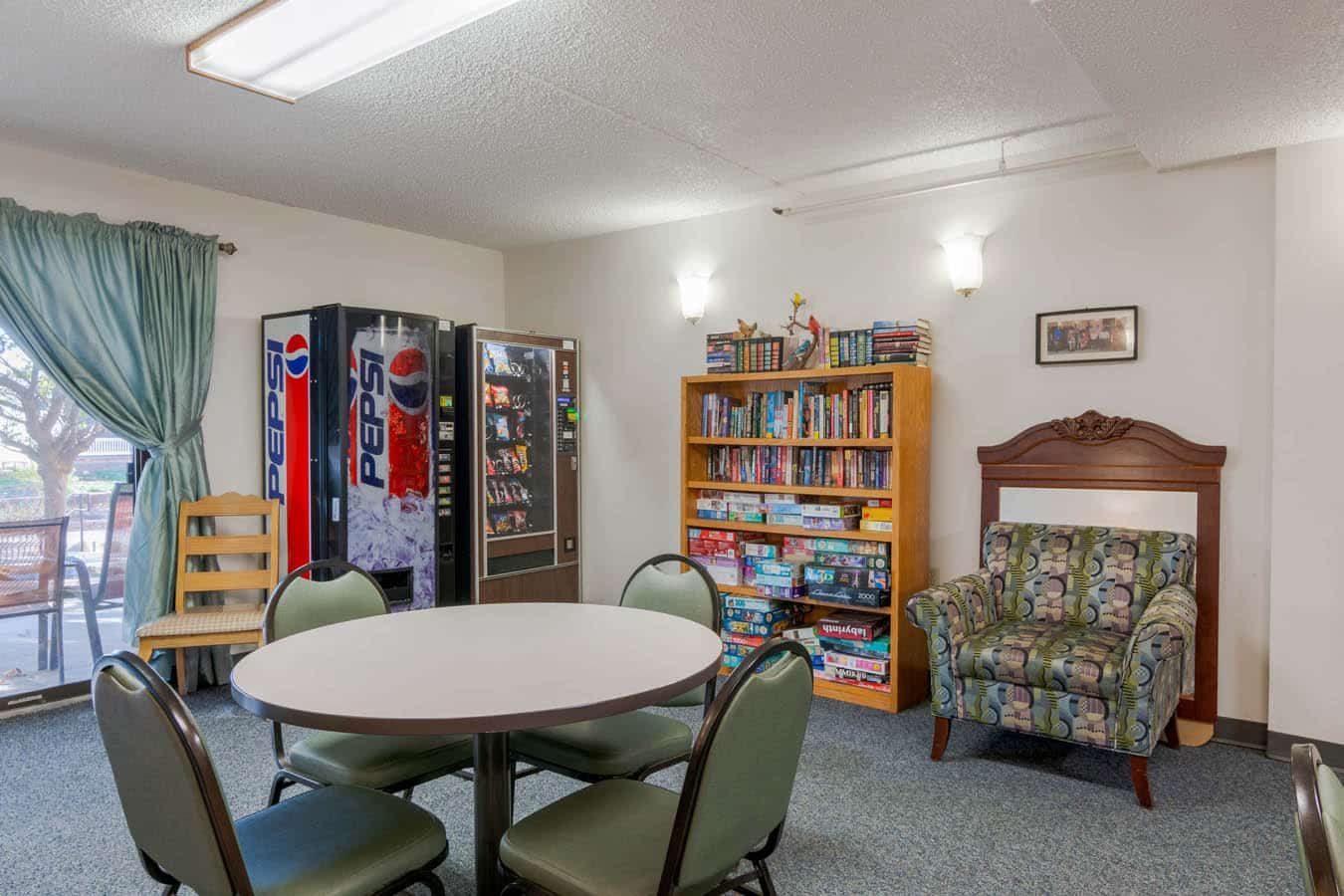 Common area with vending machines, bookshelves, and seating