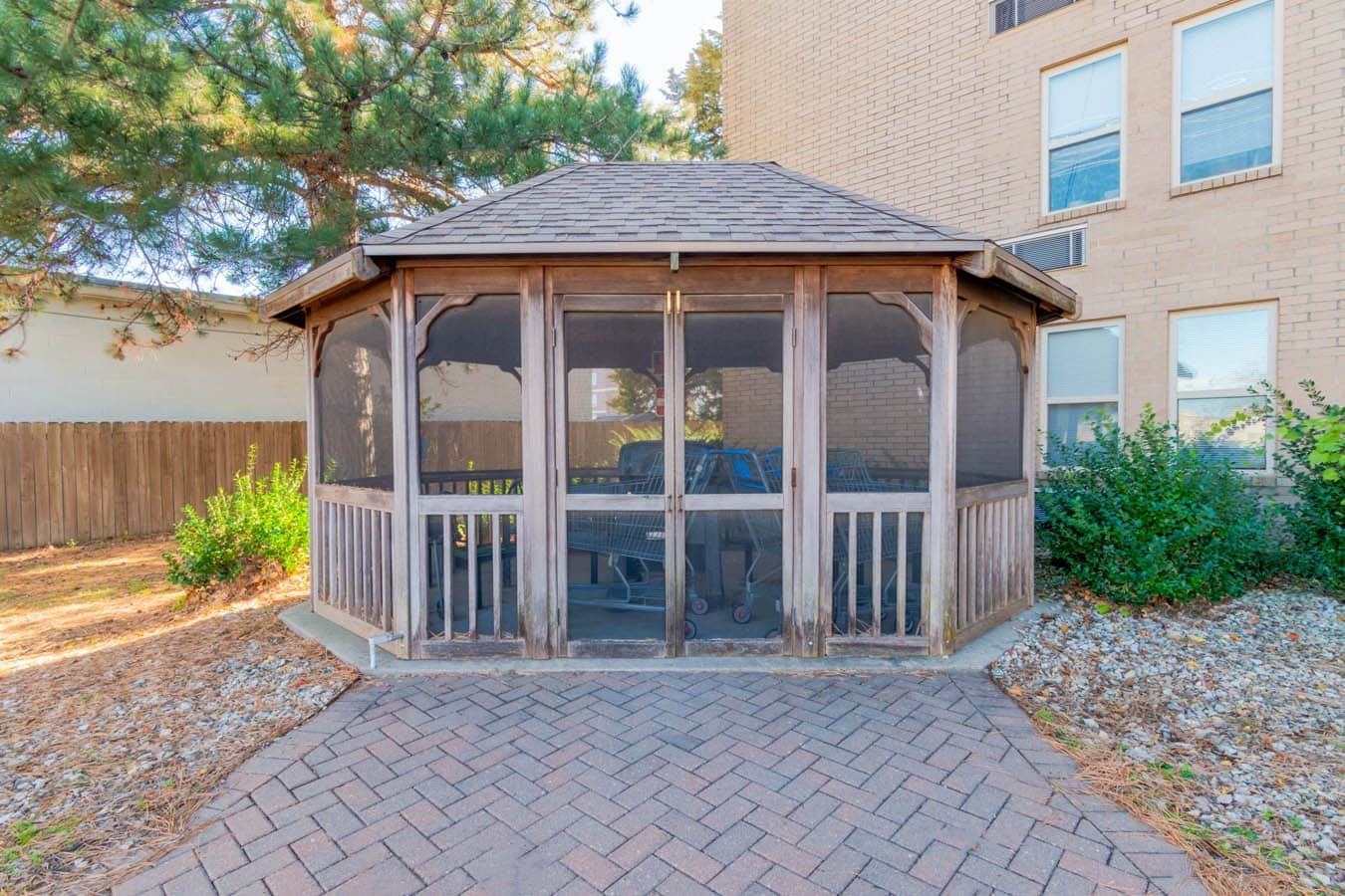 Wooden gazebo surrounded by greenery