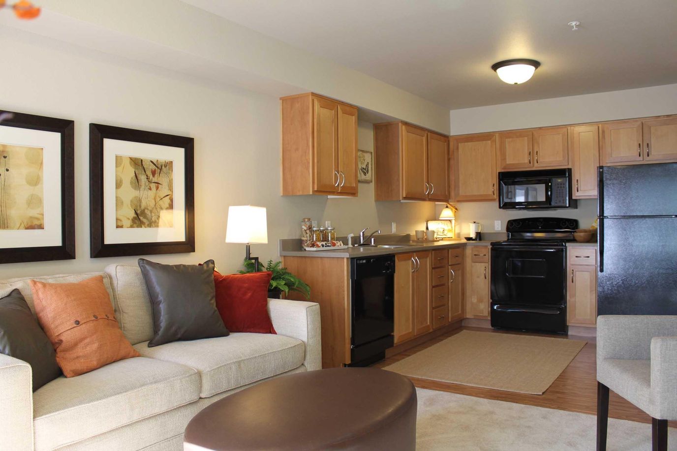 Living room with couch and adjoining kitchen area