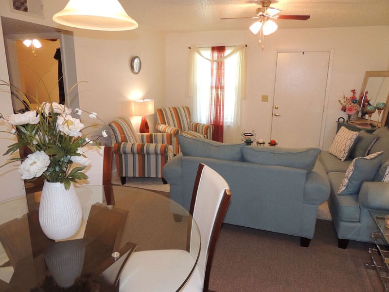 Bright living room with striped chairs and a light blue sofa