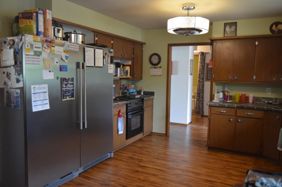 Modern kitchen with stainless steel appliances and wood cabinetry.