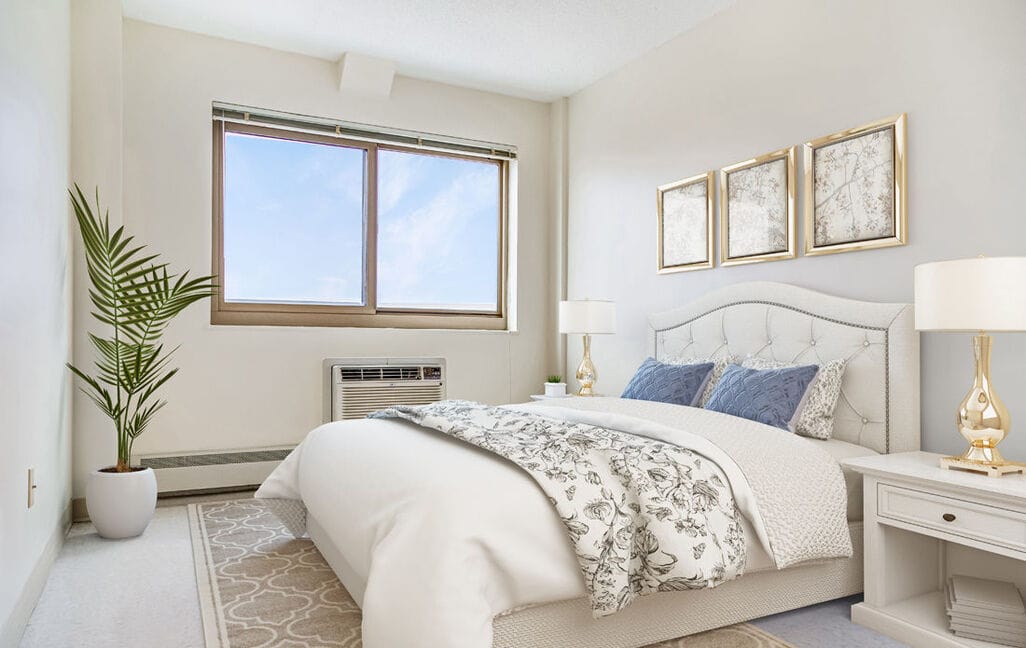 Cozy bedroom with a bed, decorative pillows, and a large window