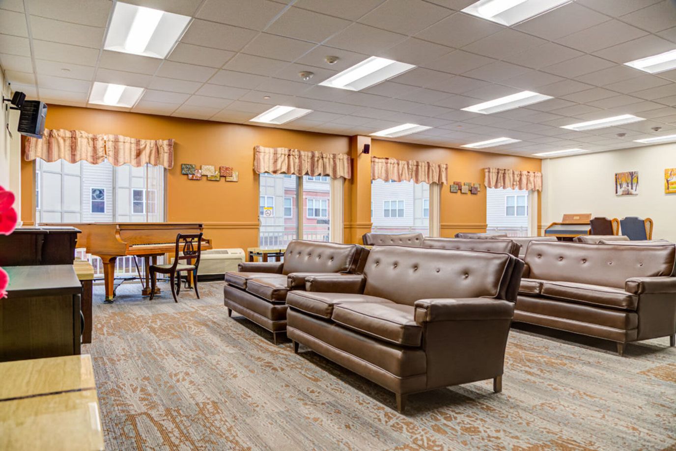 Bright common area with seating and piano