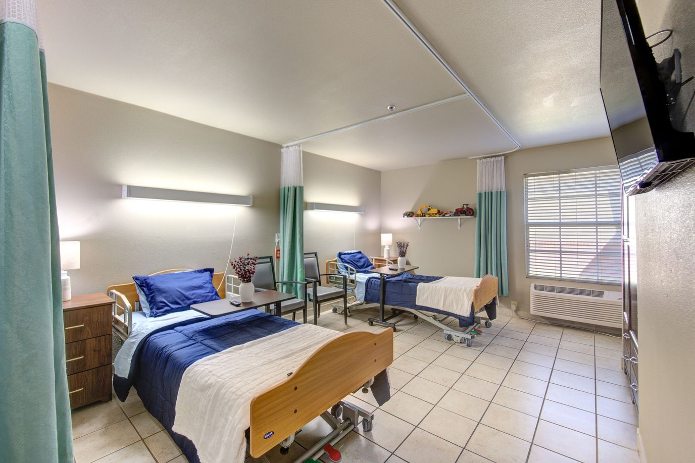 Two resident beds in a well-lit shared room