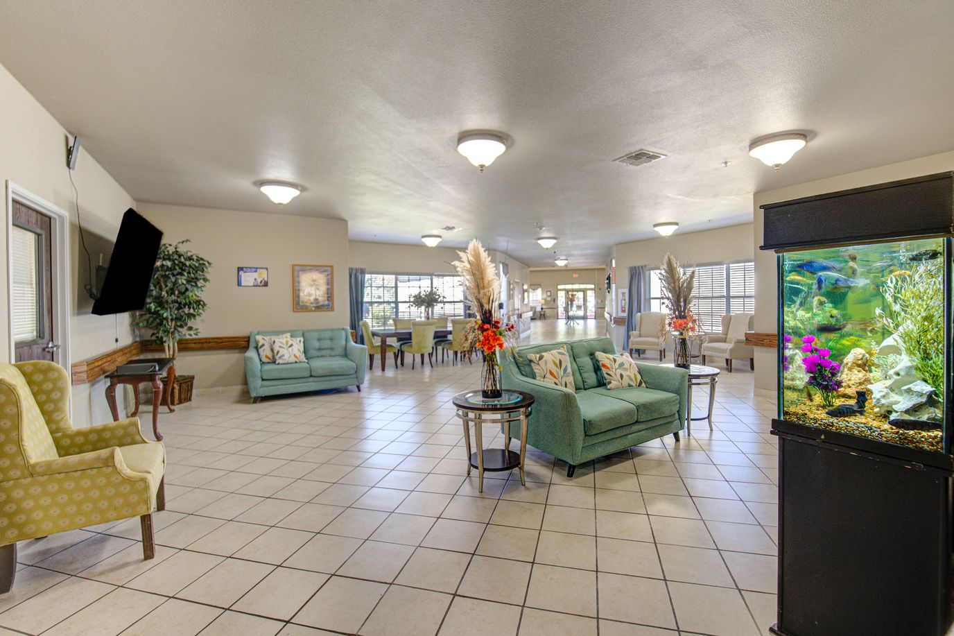Bright common area with seating and aquarium