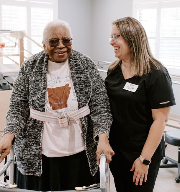 Senior resident with staff member in activity space