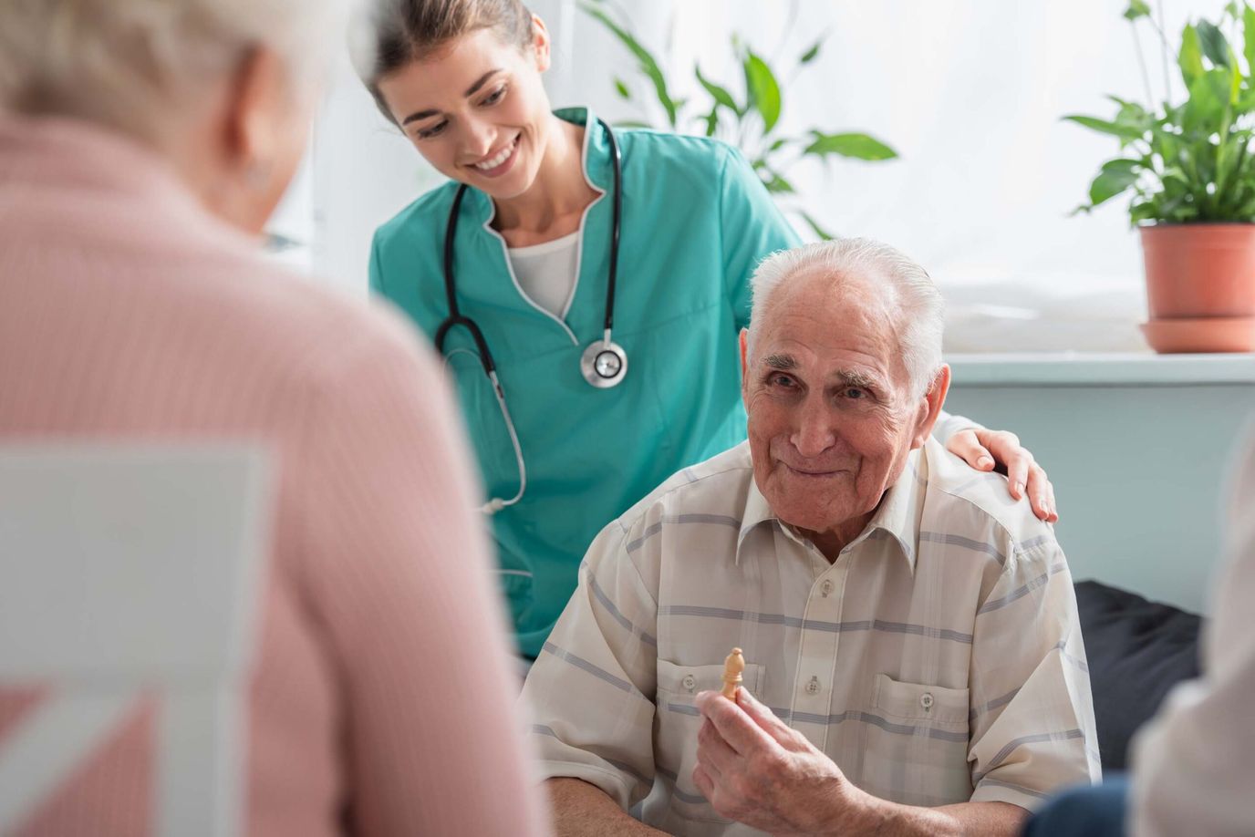 A caregiver smiling at a senior resident