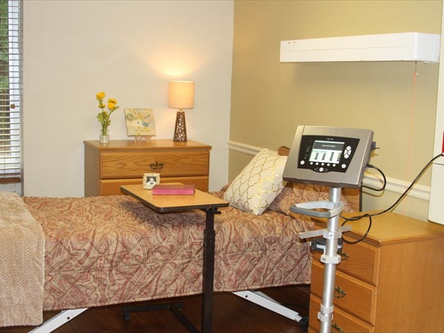 Cozy resident room with bed and lamp