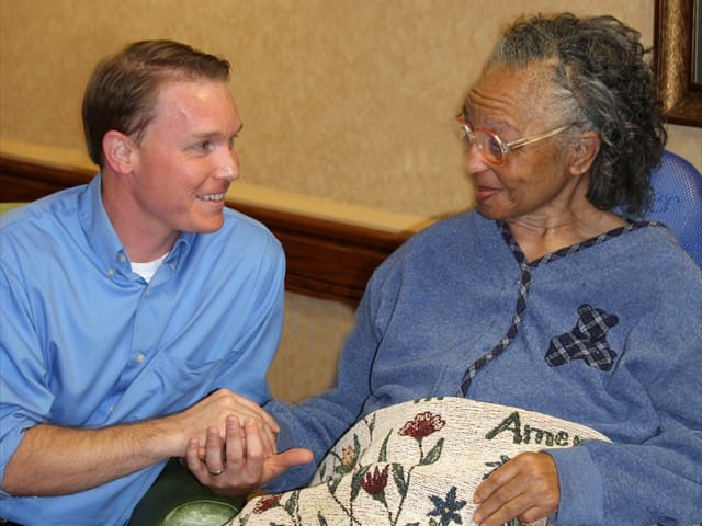 A caregiver interacting with a resident in a warm setting