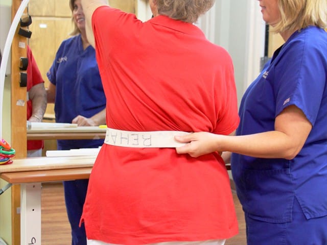 Therapist assisting resident during rehabilitation