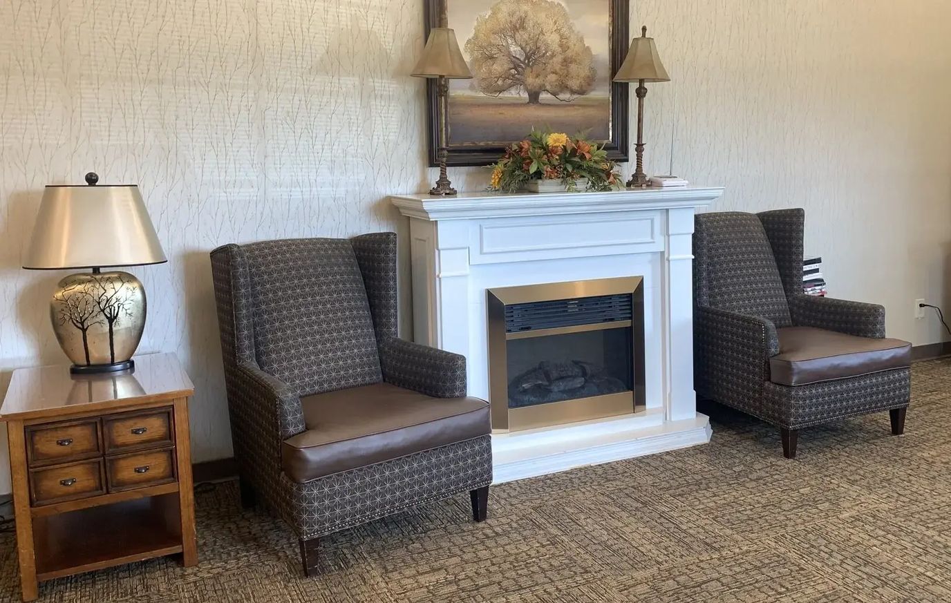 Cozy common area with comfortable armchairs and a fireplace